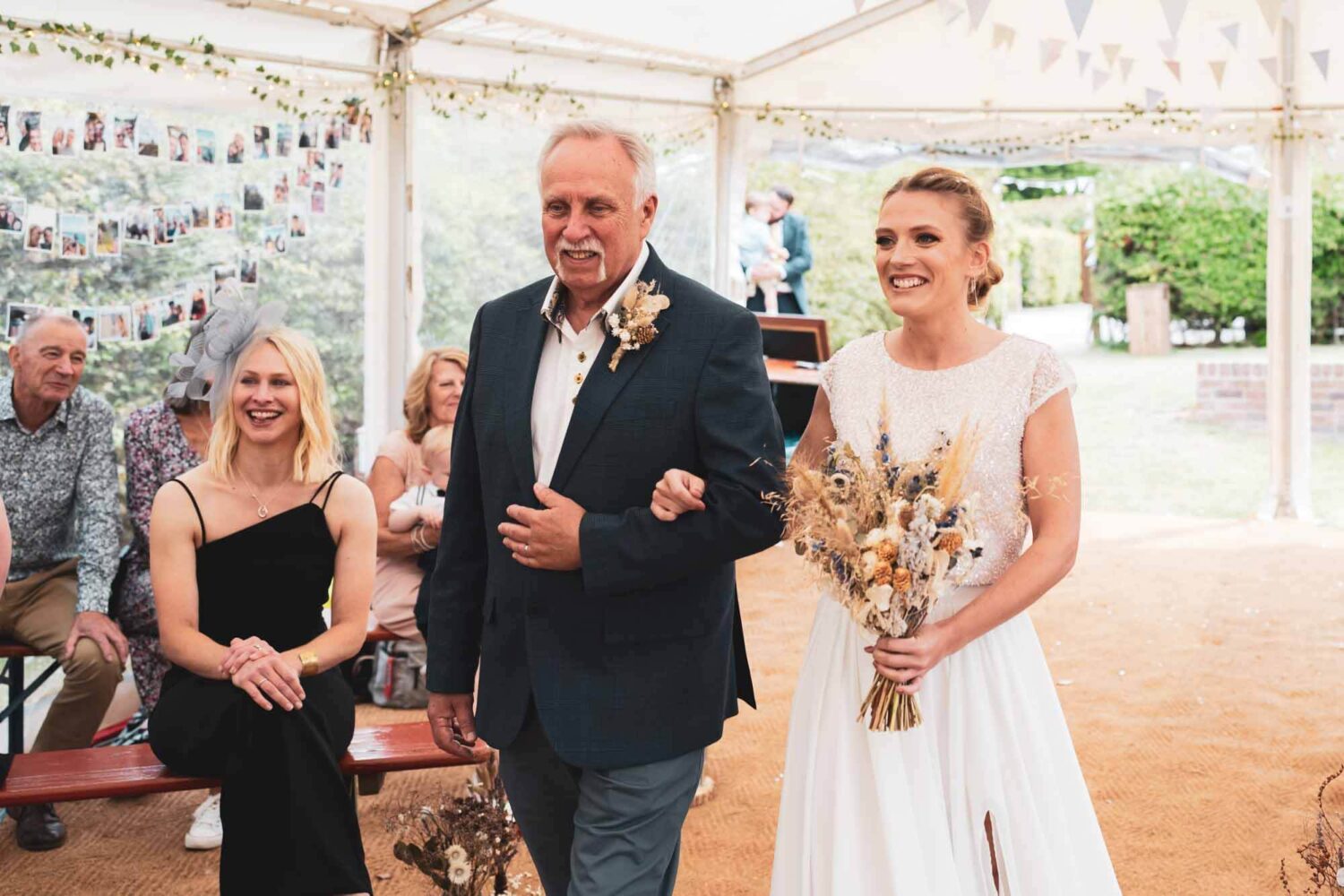 father of the bride and bride walking down the aisle in marque