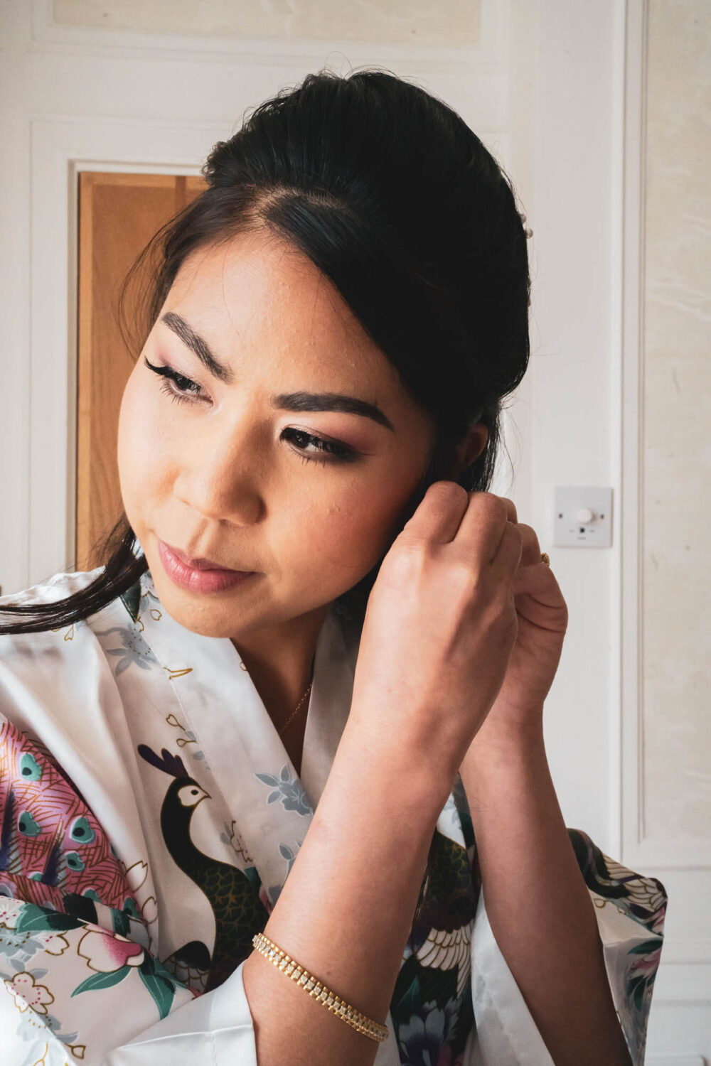 bride putting on earring
