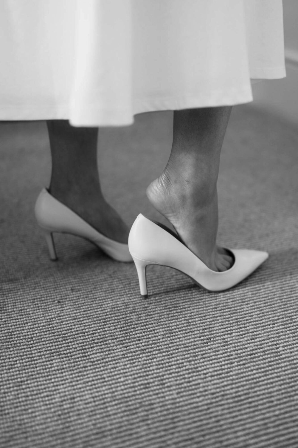 close up of bride putting on her shoes
