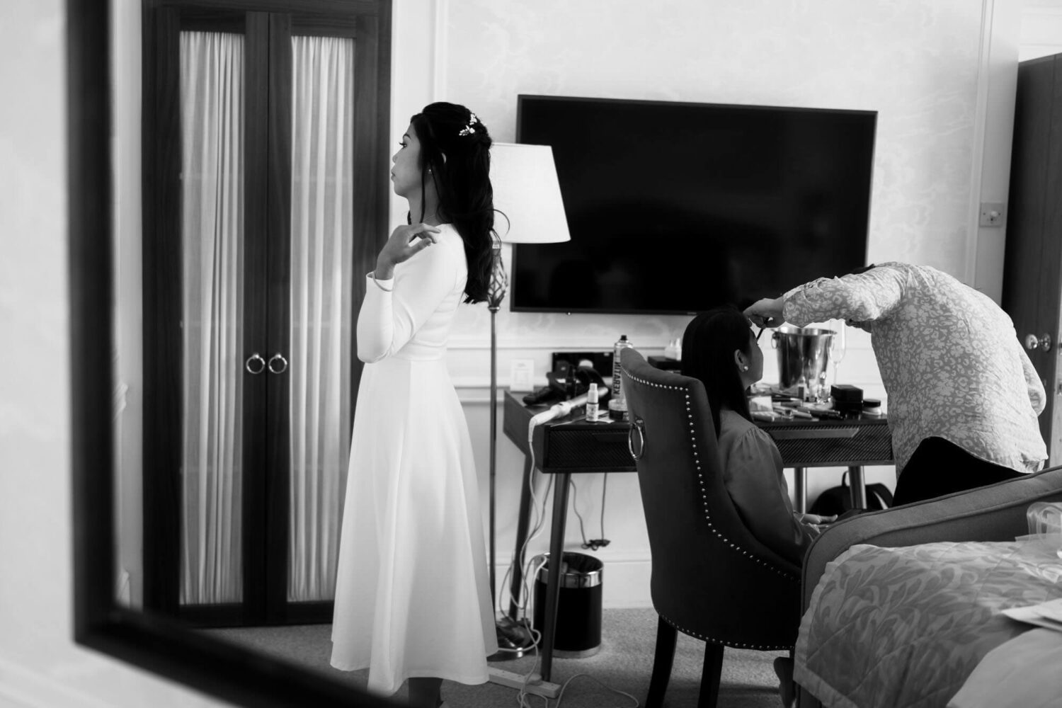bride checks herself for the last time in the mirror
