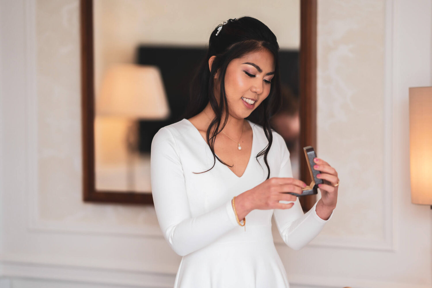 bride opening a pair of earrings given to her by her husband to be