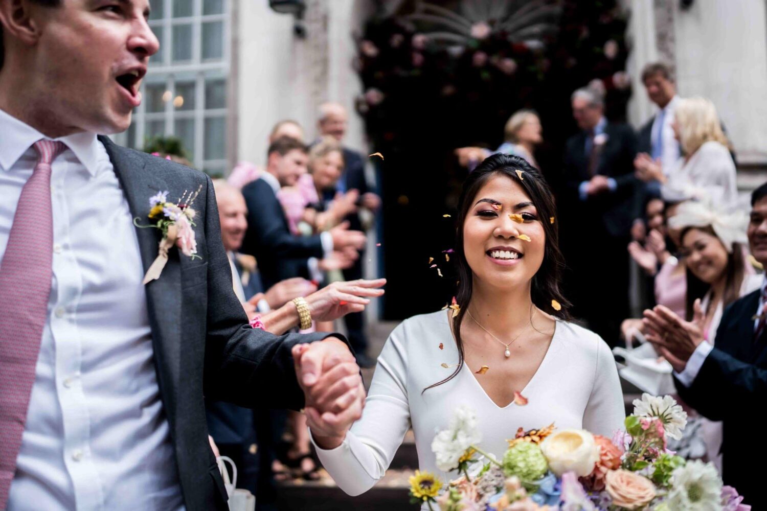 confetti over couple walking out of chelsea town hall