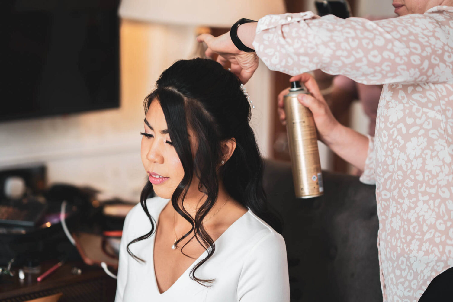 bride having hair spray on