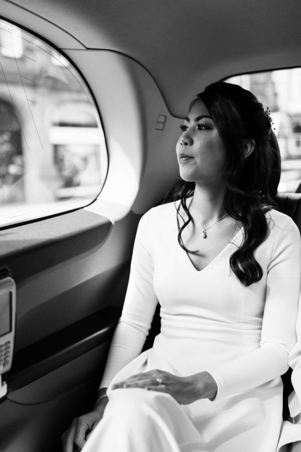 bride looking pensive in a taxi on way to registry office