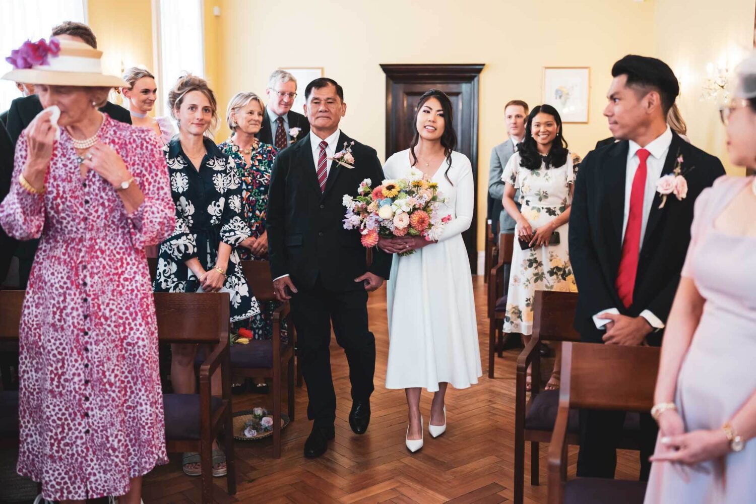 bride walking down aisle with her dad