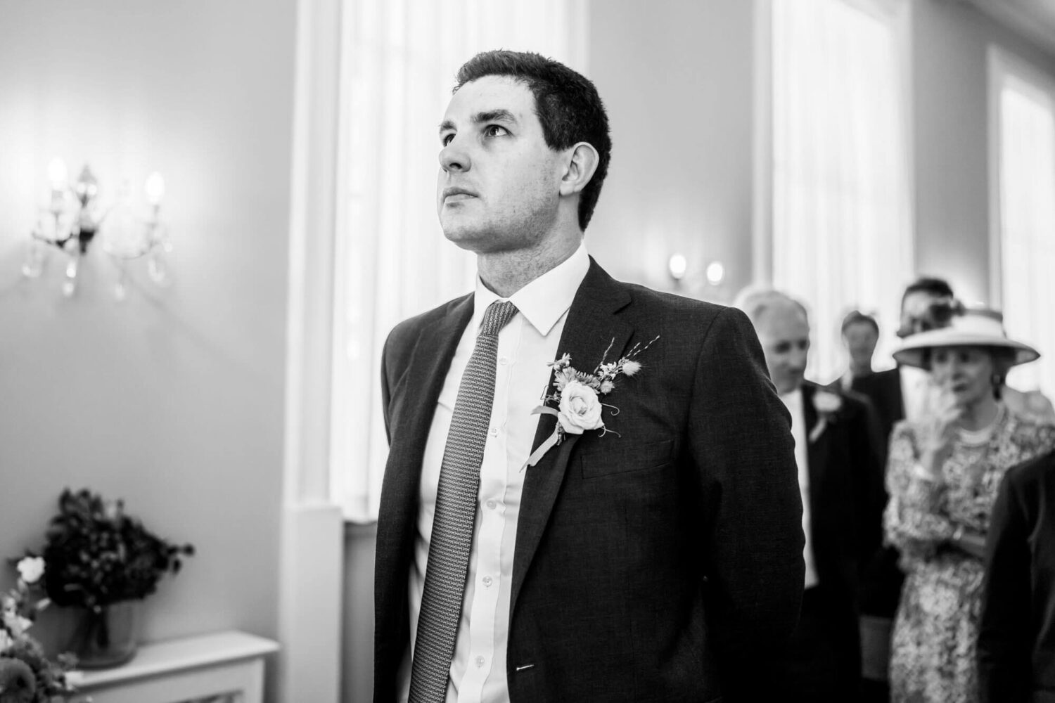 tearful groom looking up waiting to see his bride for the first time