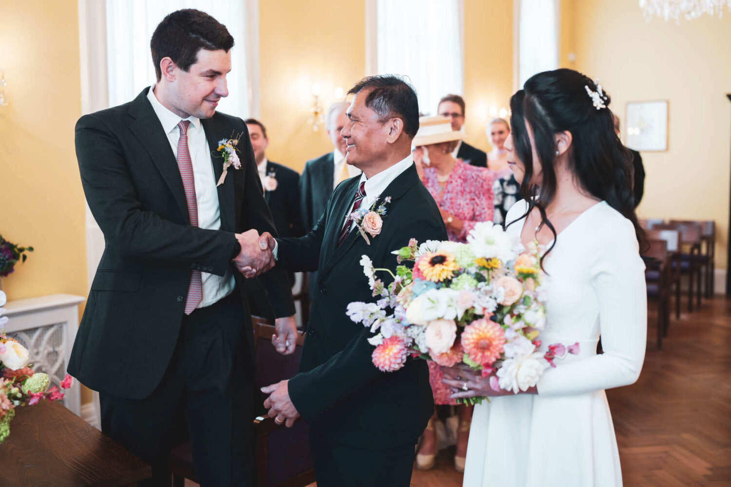 groom and father in law shaking hands