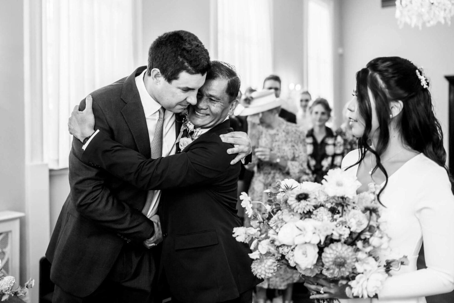 groom and father in law giving each other a hug before he hands over his daughter
