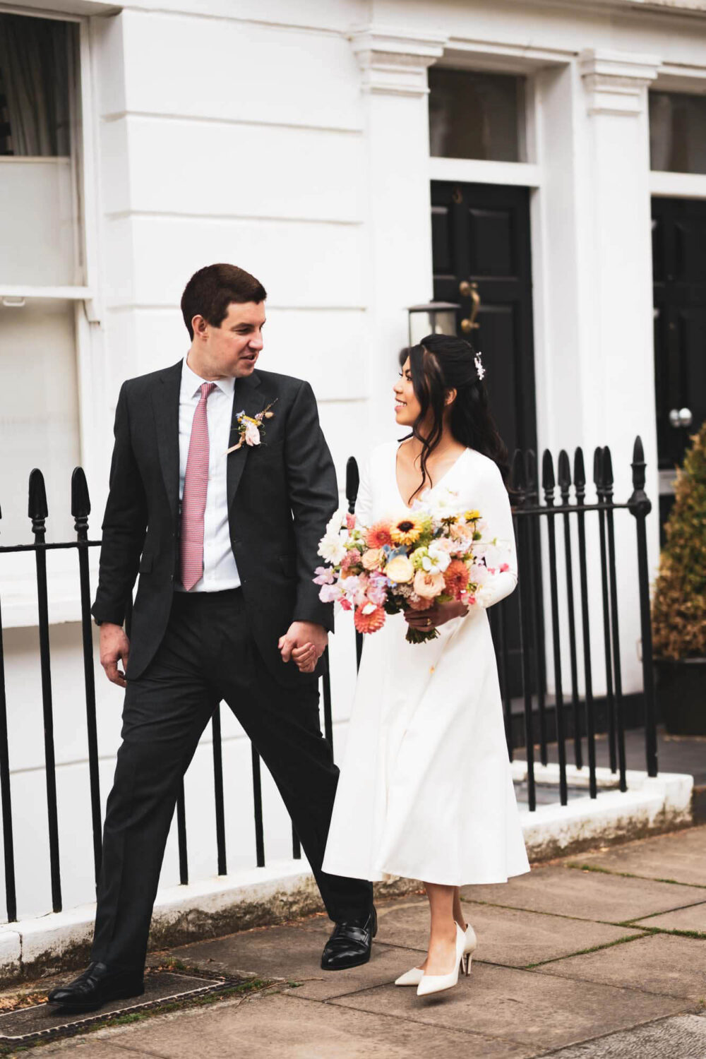 groom and bride striding along a street in Chelsea
