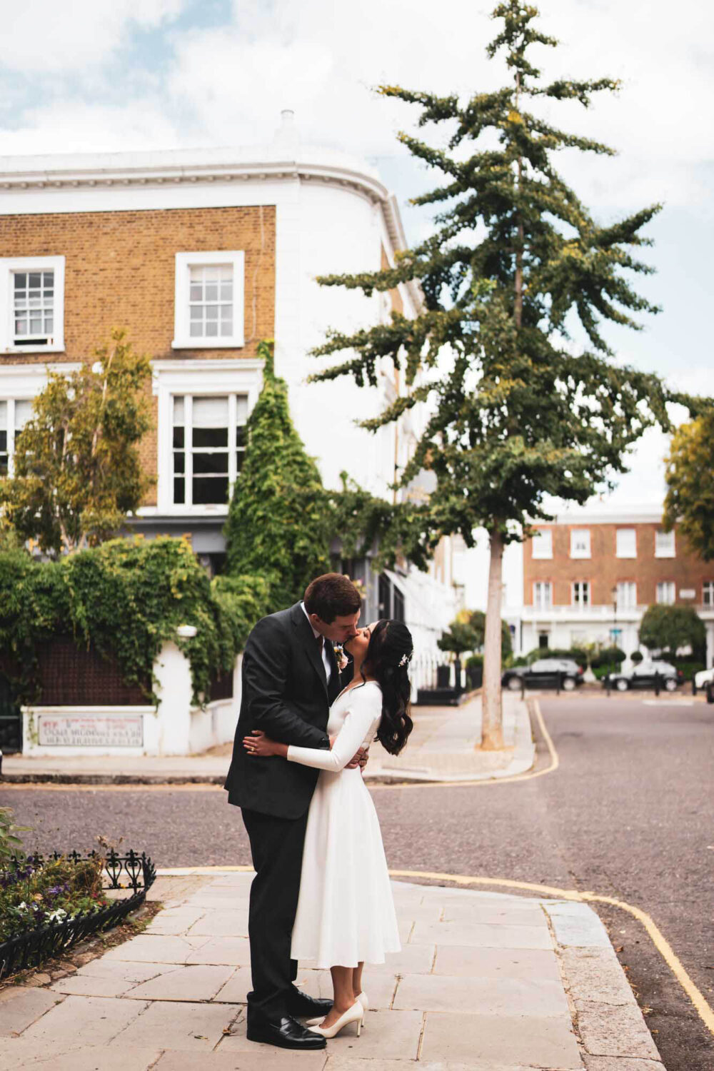 groom and bride having a kiss on gorgeous Chelsea road