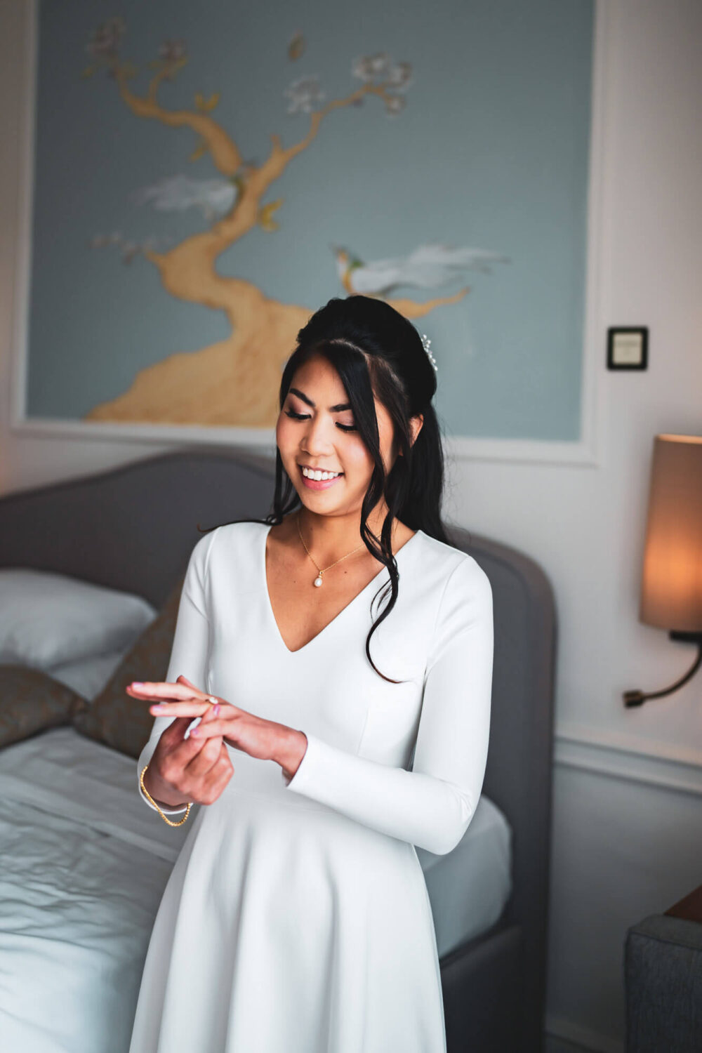 bride smiling looking down at her engagement ring