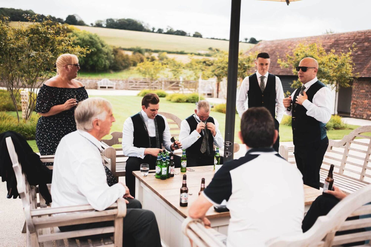 natural shot of groom's party doing up ties