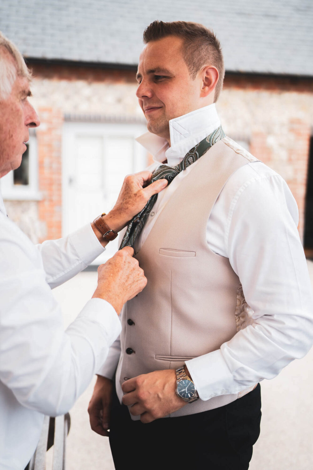 father doing son's tie up