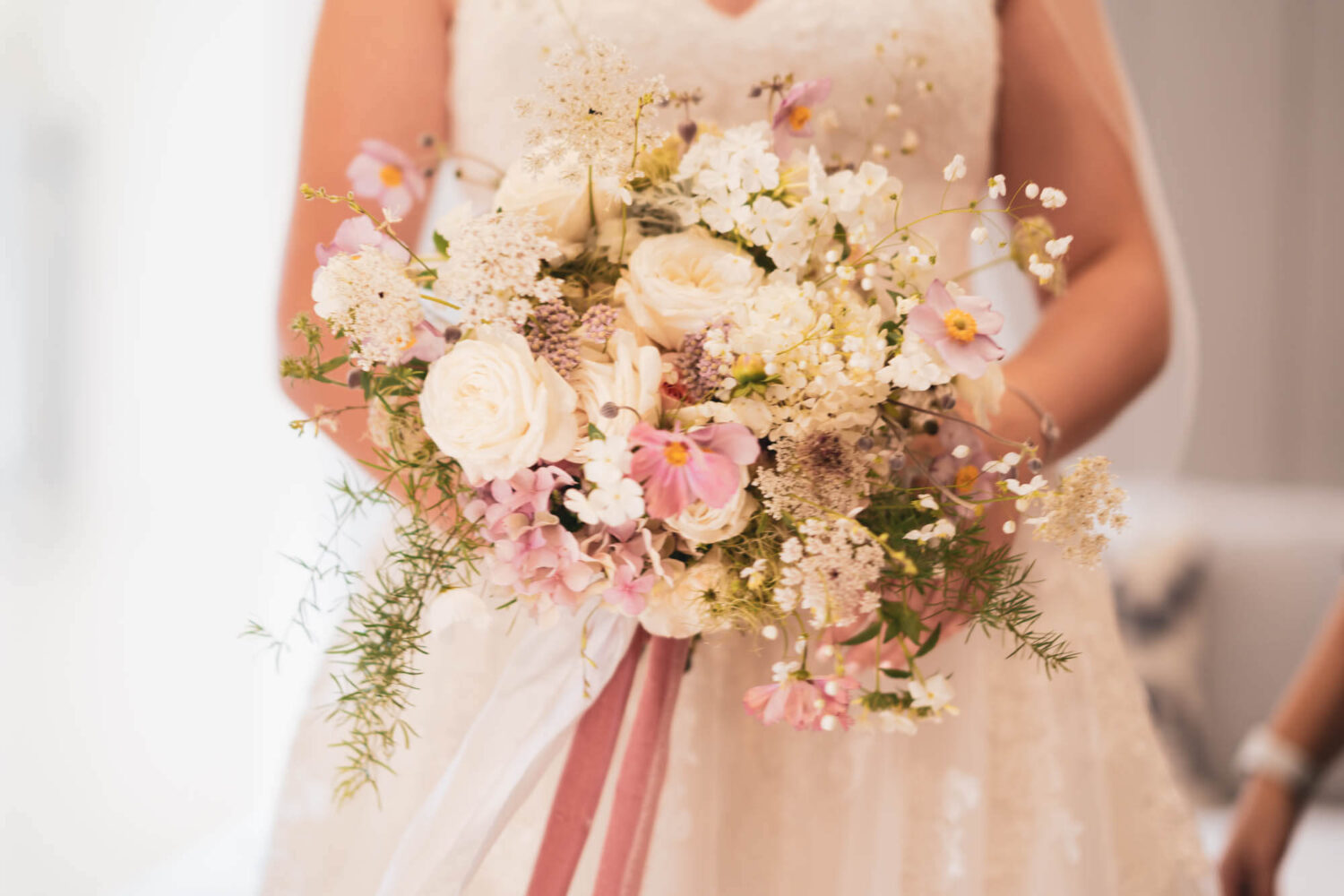 close up of bride holding bouquet