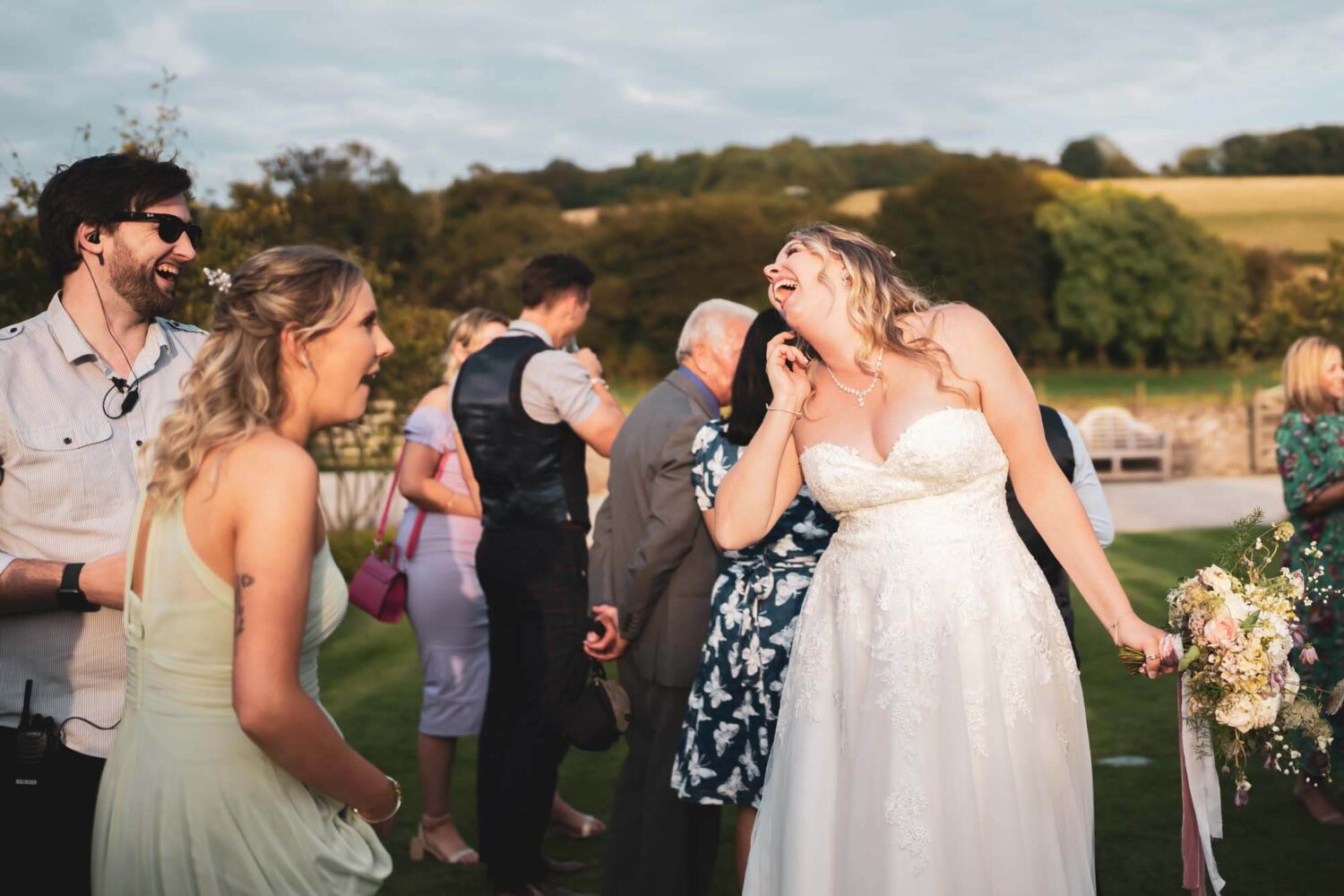 bride laughing with her sister at farbridge on her wedding day