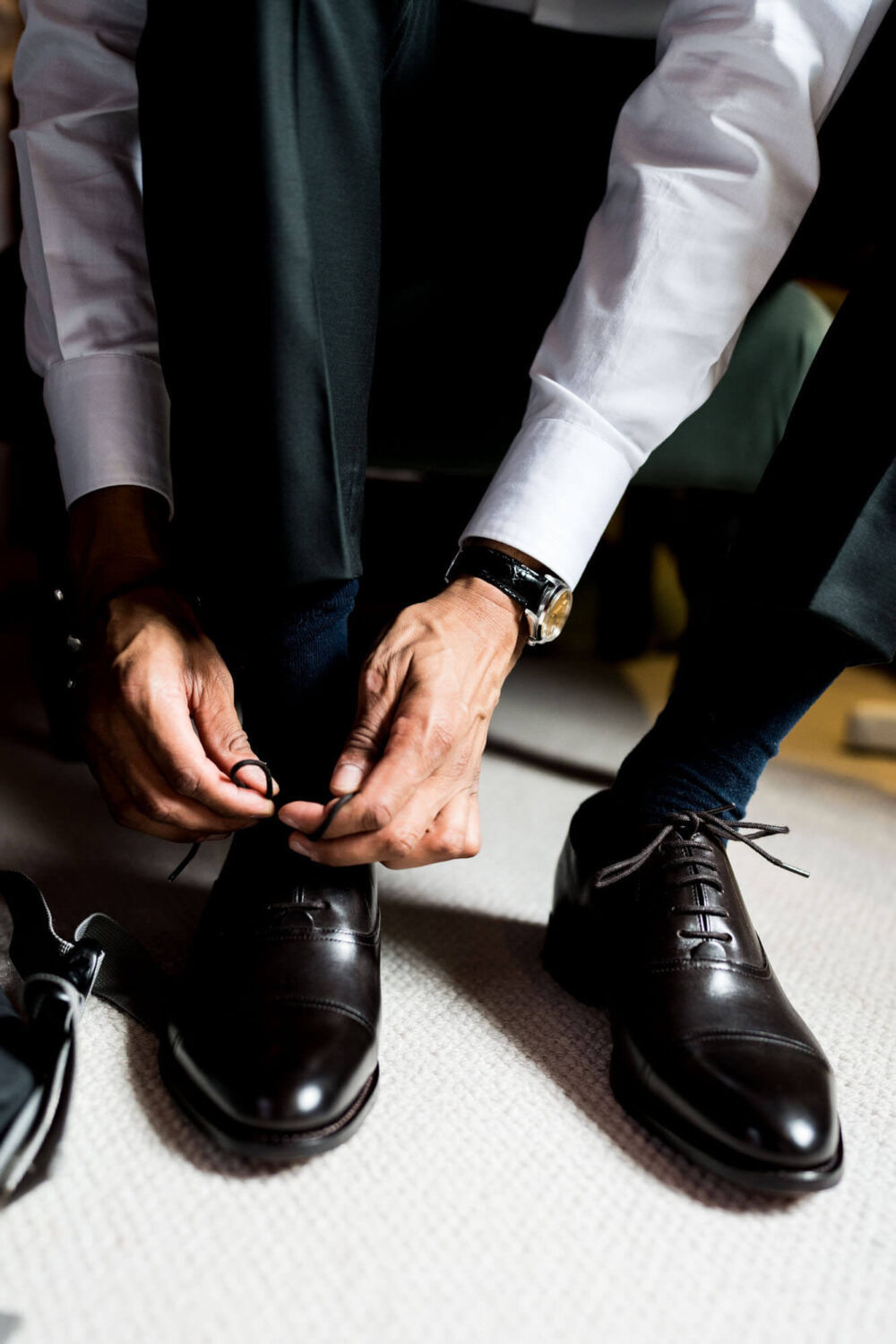 groom doing up his shoe laces