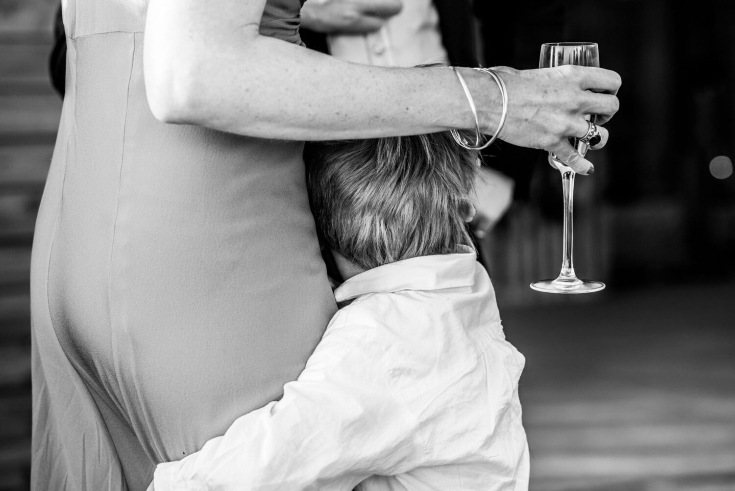 boy hugging his mother's leg