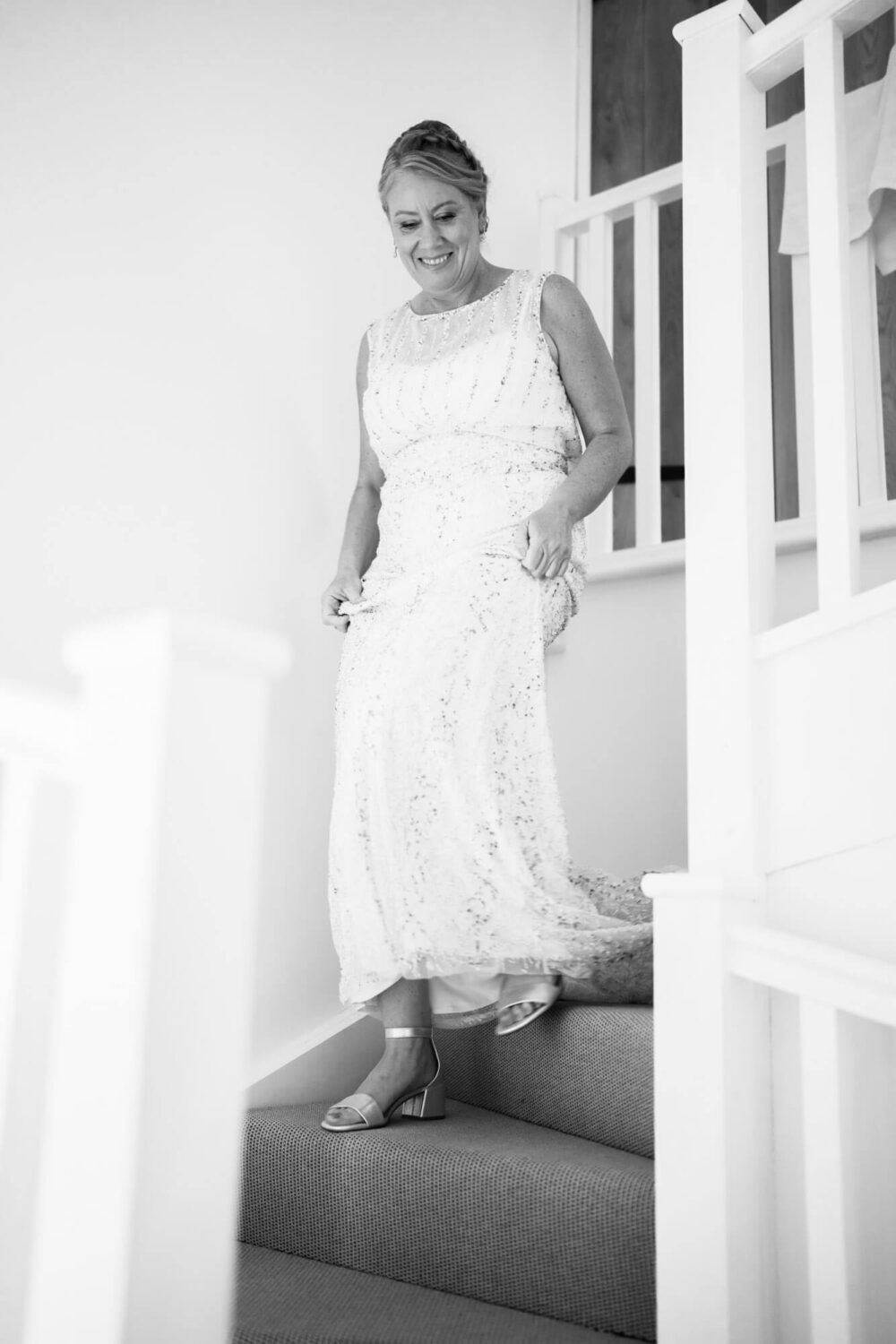 bride walking down the stairs for first view of her dress