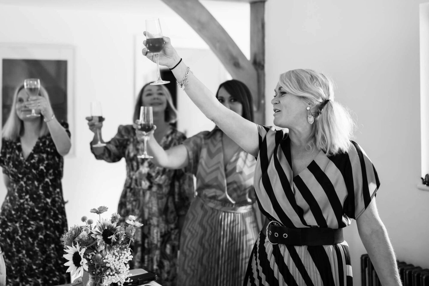 best women raising a glass to the bride