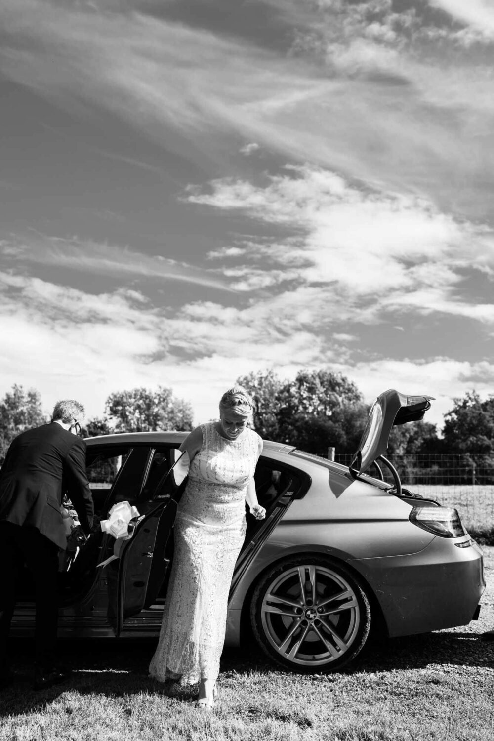 bride stepping out of car arriving at venue