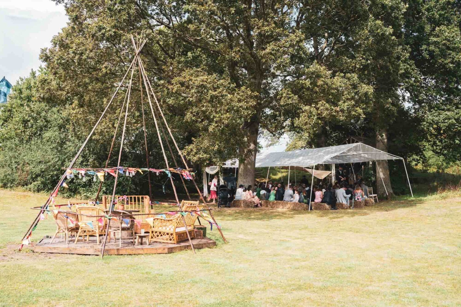 festival style field with open tipi and ceremony area