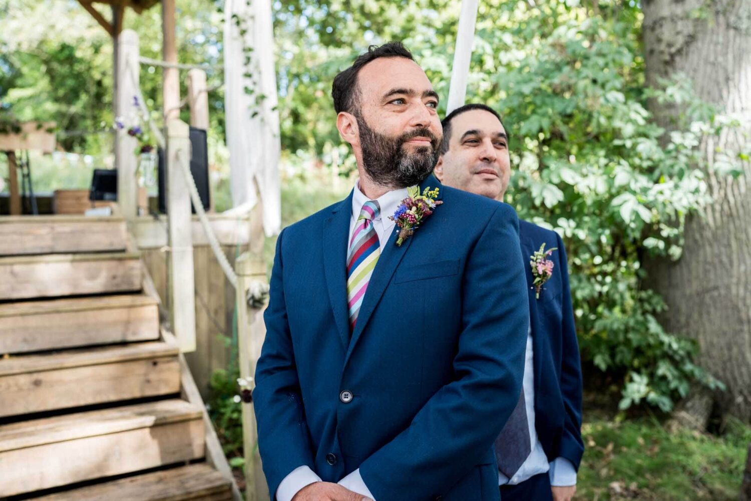 groom looking towards bridal party arriving