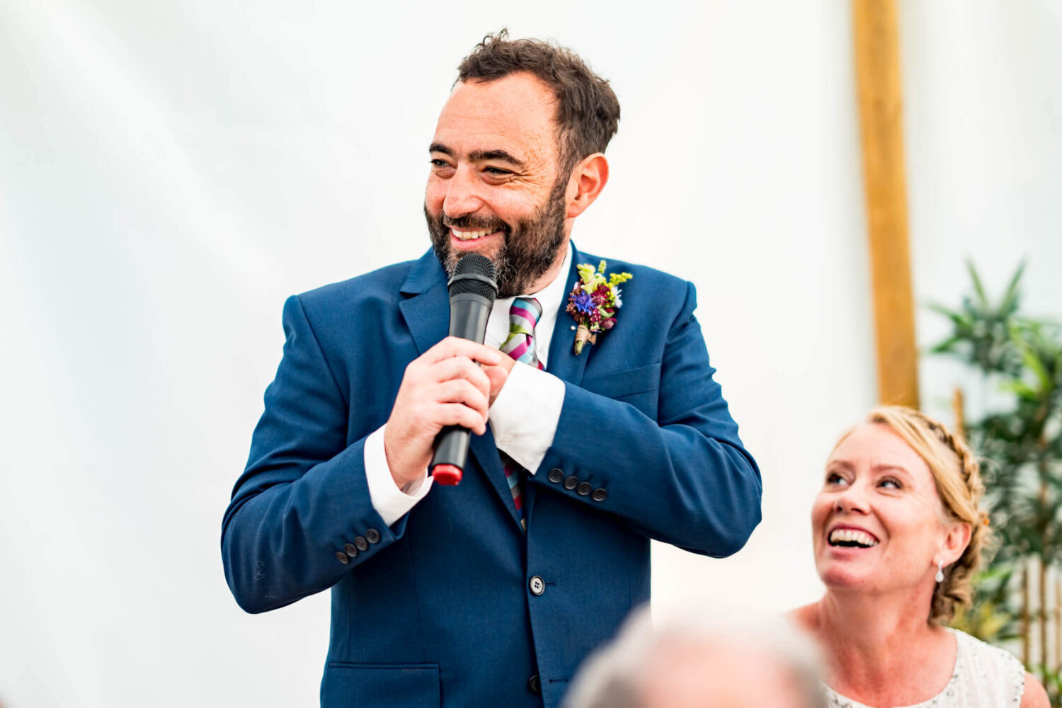 groom doing a speech holding microphone