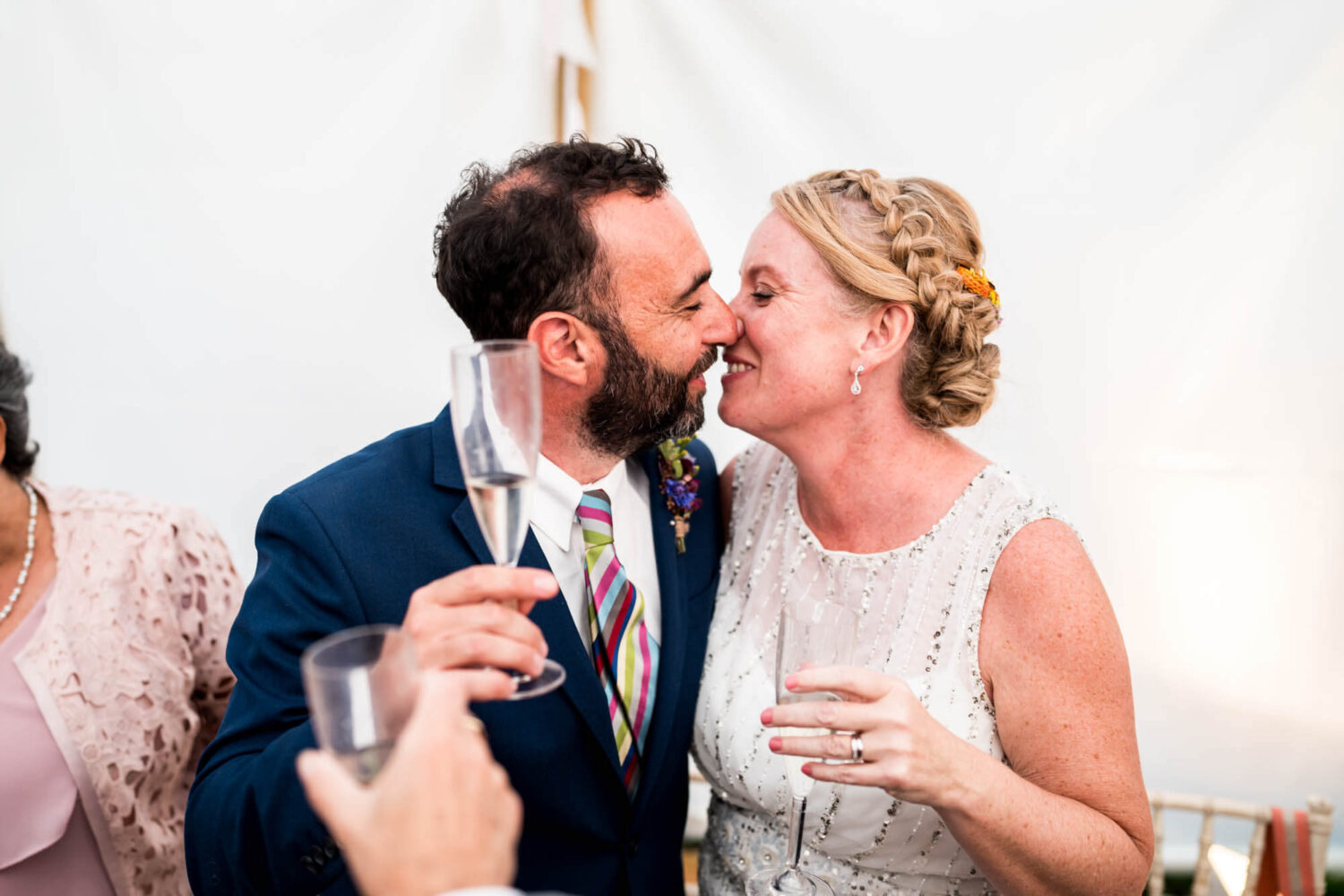 bride and groom kissing at end of speeches