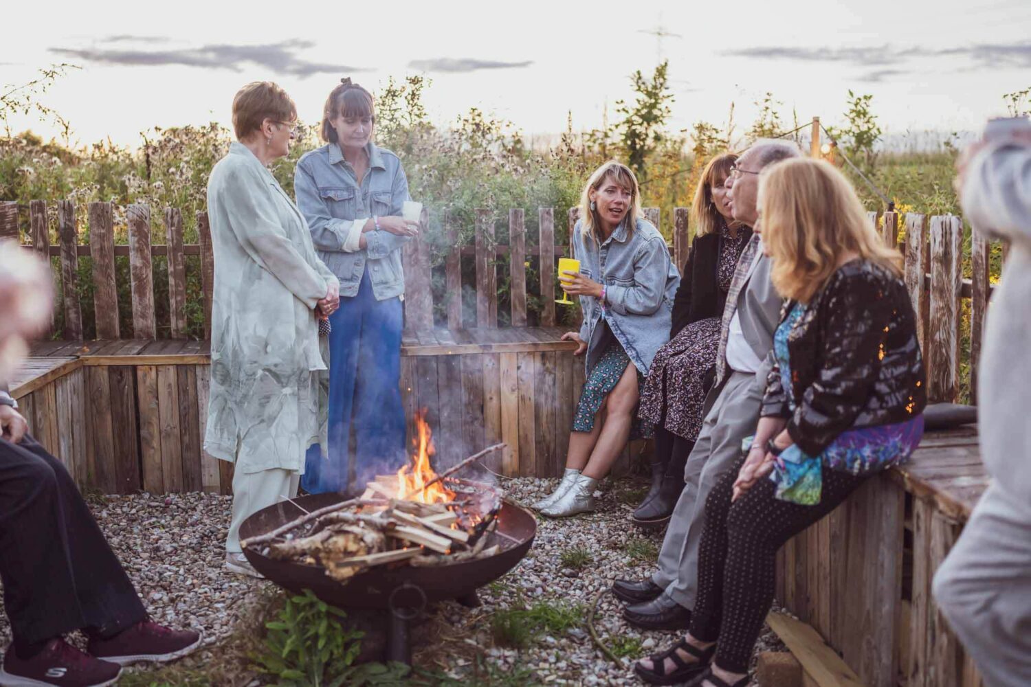 guests hanging out around a campfire