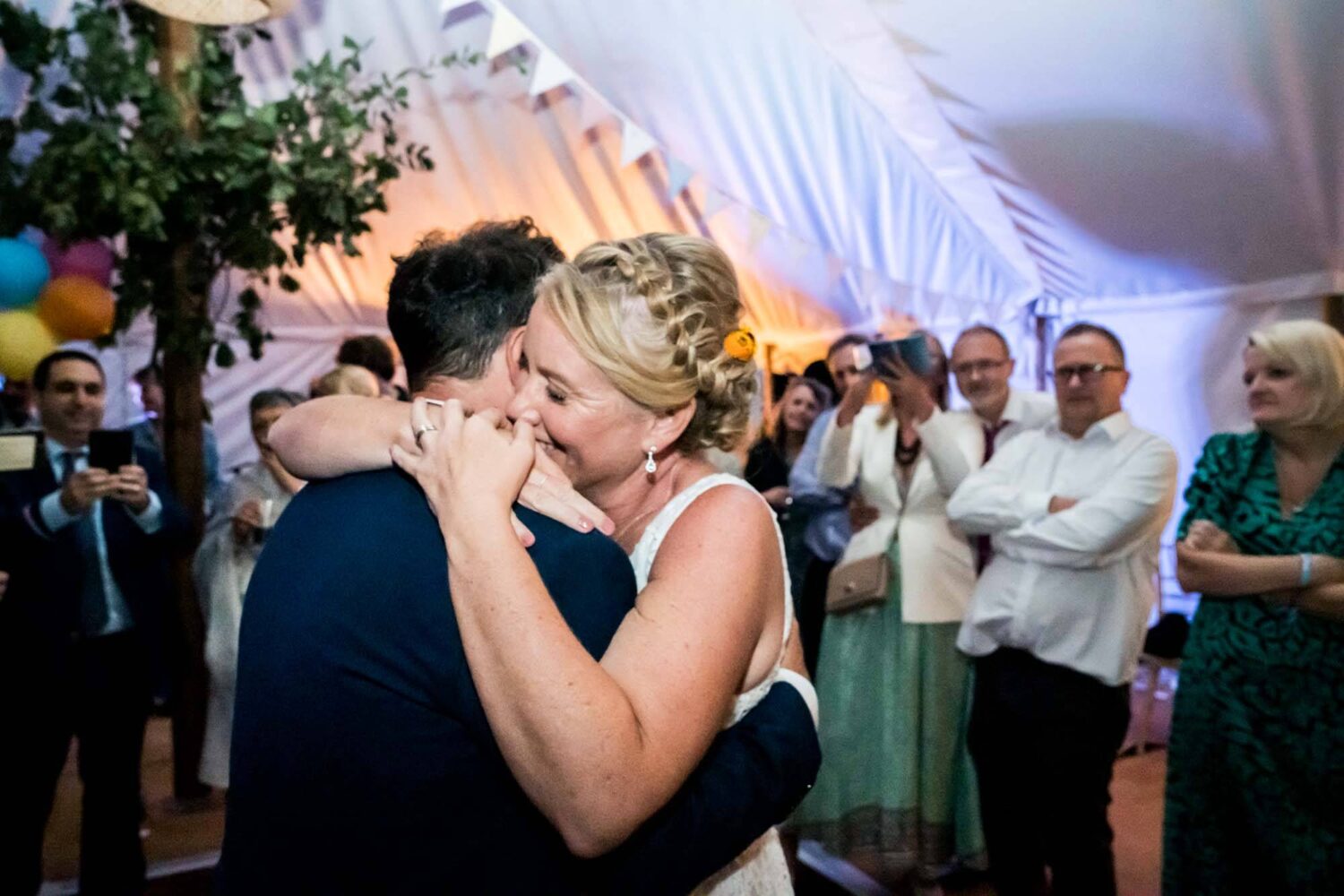 bride and groom doing first dance hugging