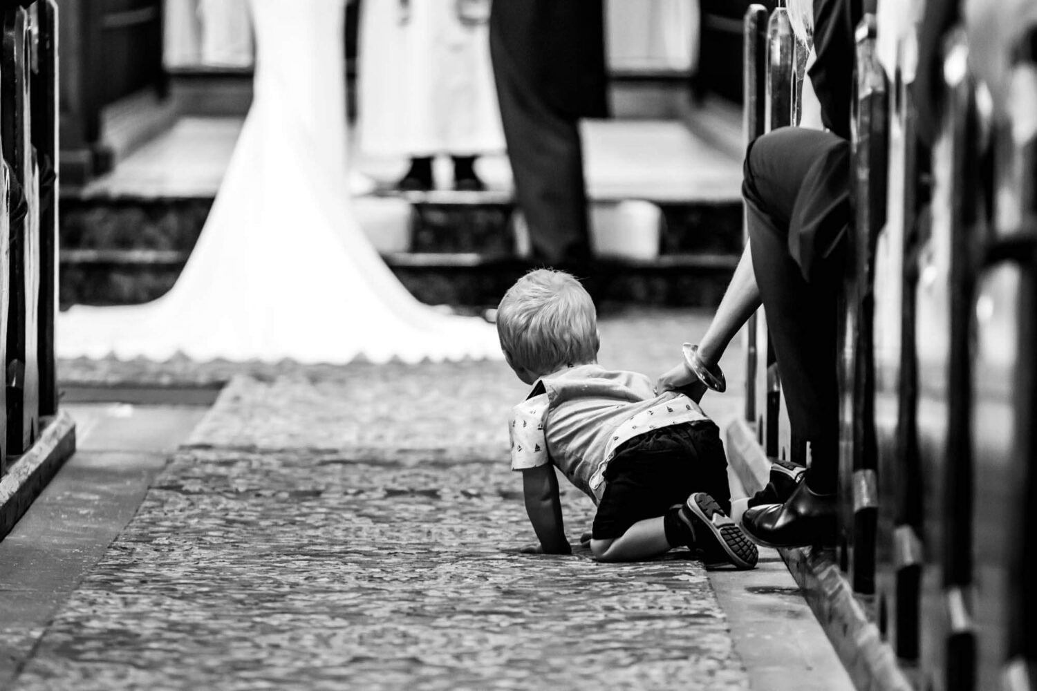 kid trying to escape down aisle with mums hand stretched out
