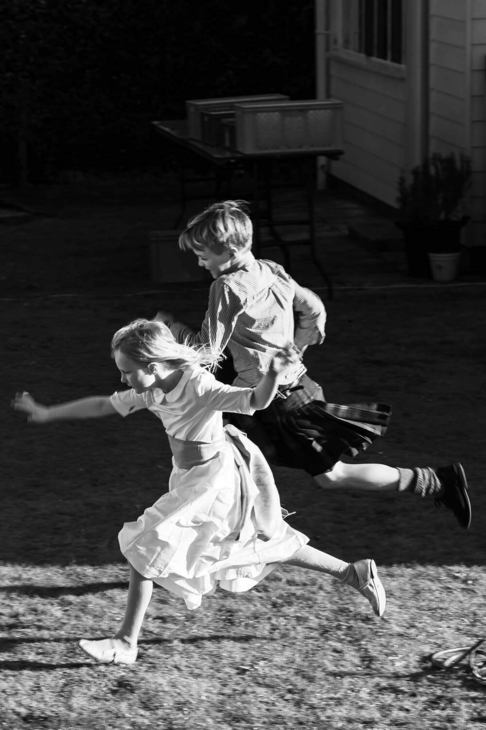 kids running through garden at wedding
