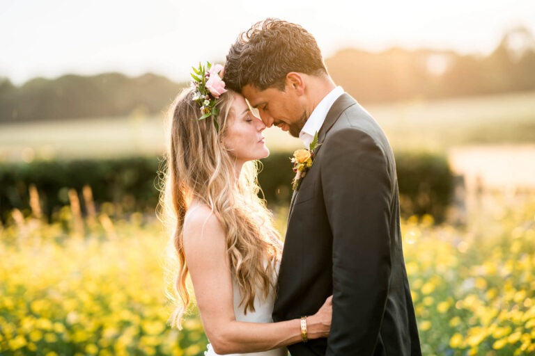 bride and groom close up noses touching golden hour coming through