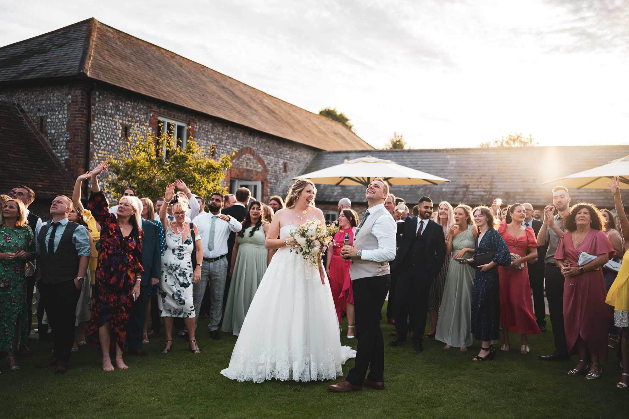wedding party looking up at drone