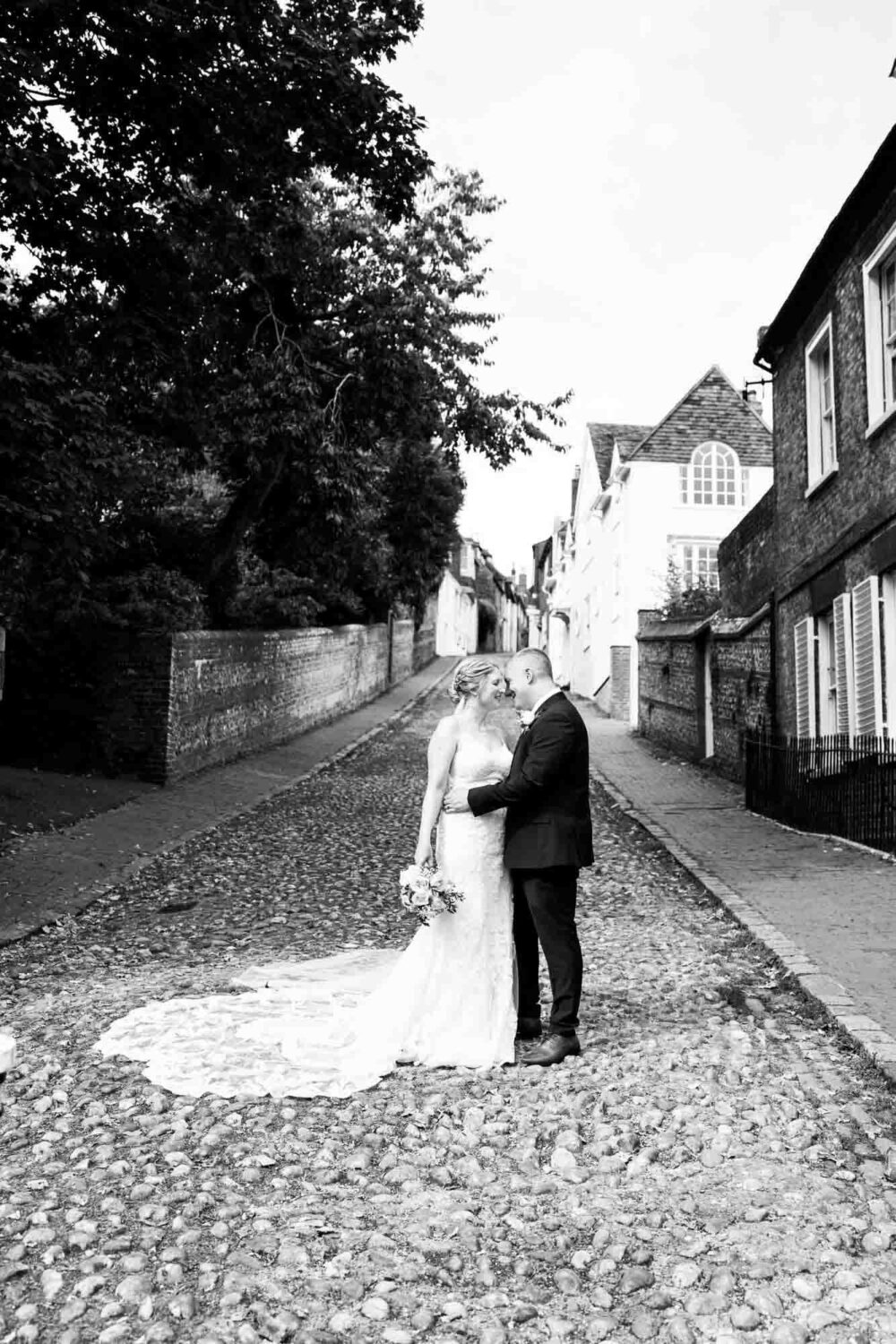 bride and groom standing on keele street in lewes really picturesque cobbled street