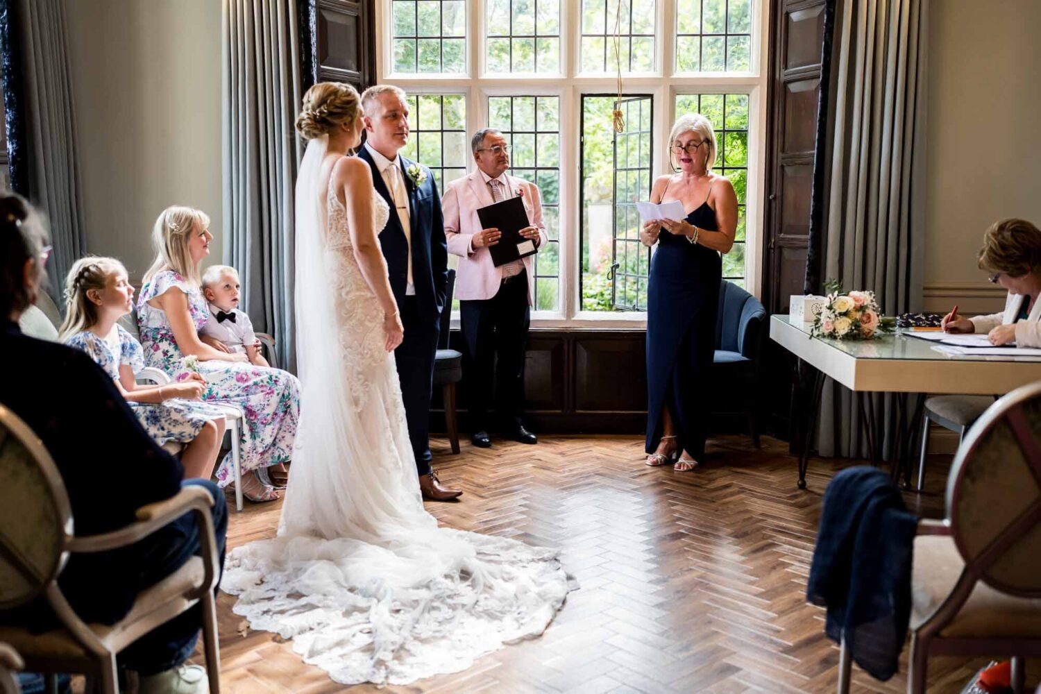 bride and groom listening to reading by one of the guests
