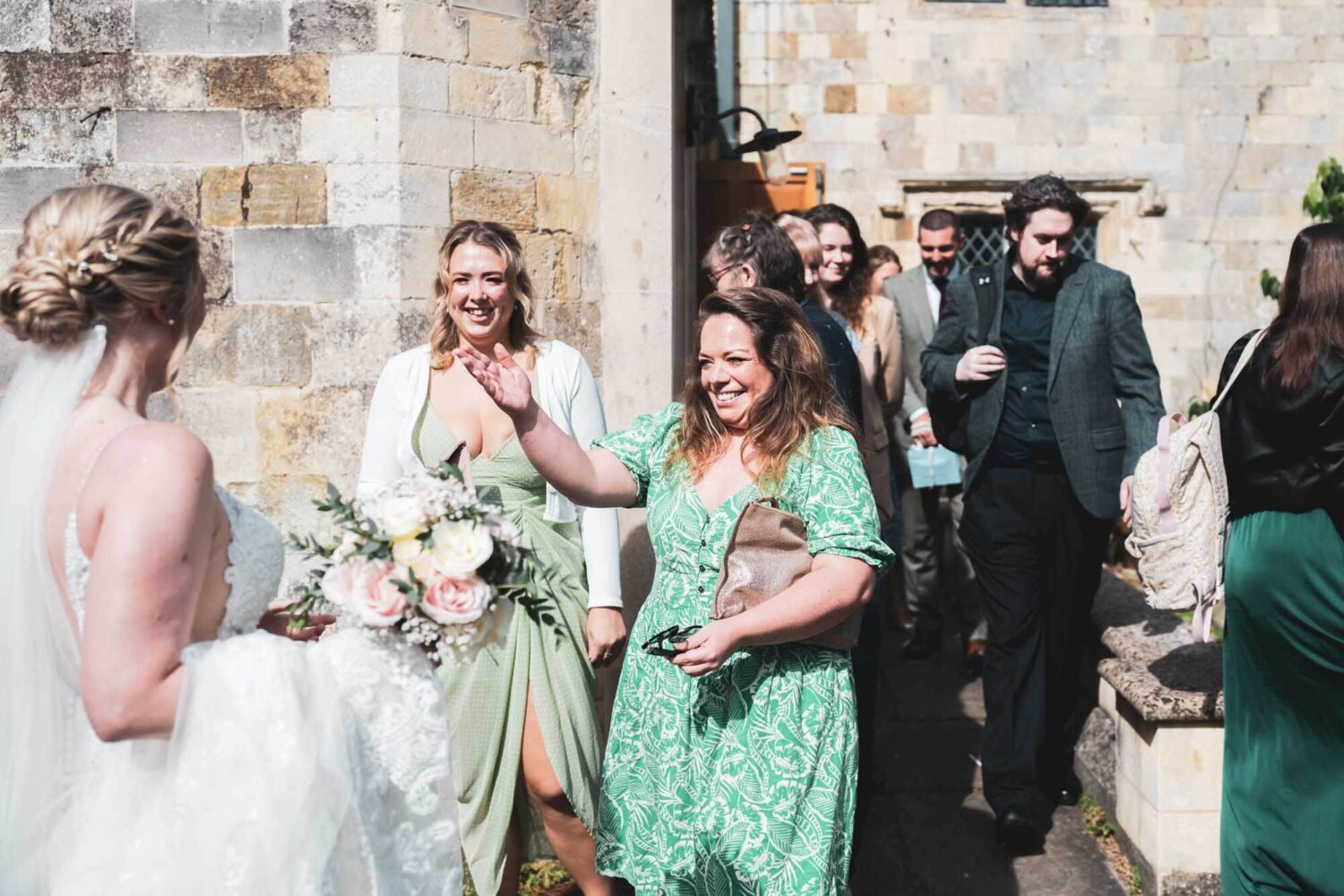 guests greet bride in gardens after ceremony
