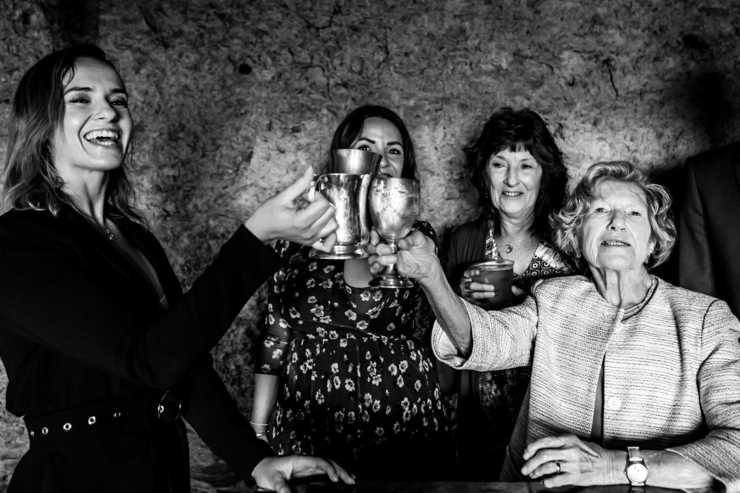 group of guests old and young saying cheers with goblets of beer