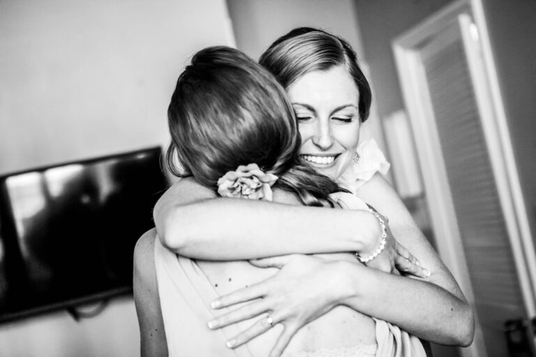 bride hugging her best friend smiling