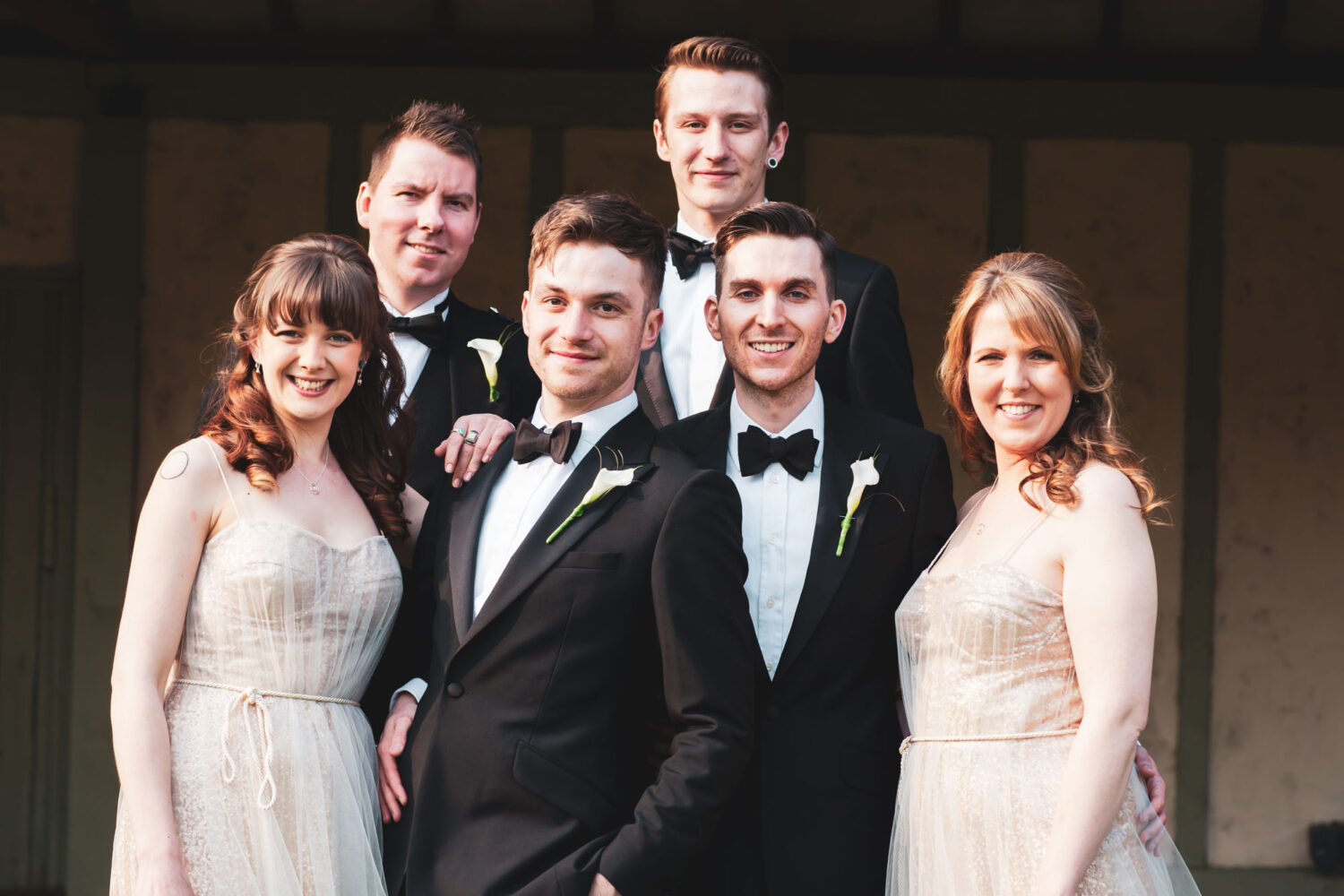 two grooms with their wedding party