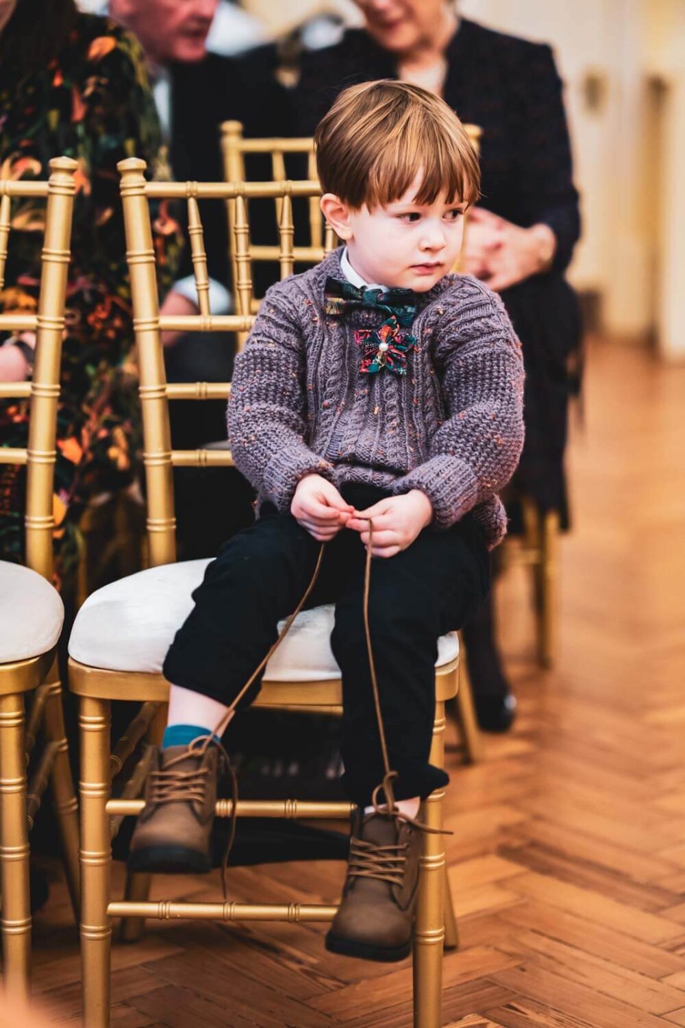 kid playing with his shoe laces