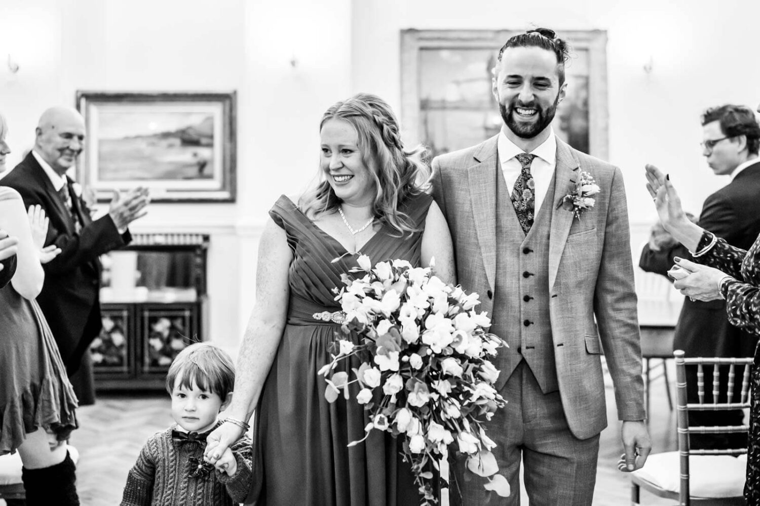 walking back down the aisle bride and groom and son in brighton town hall