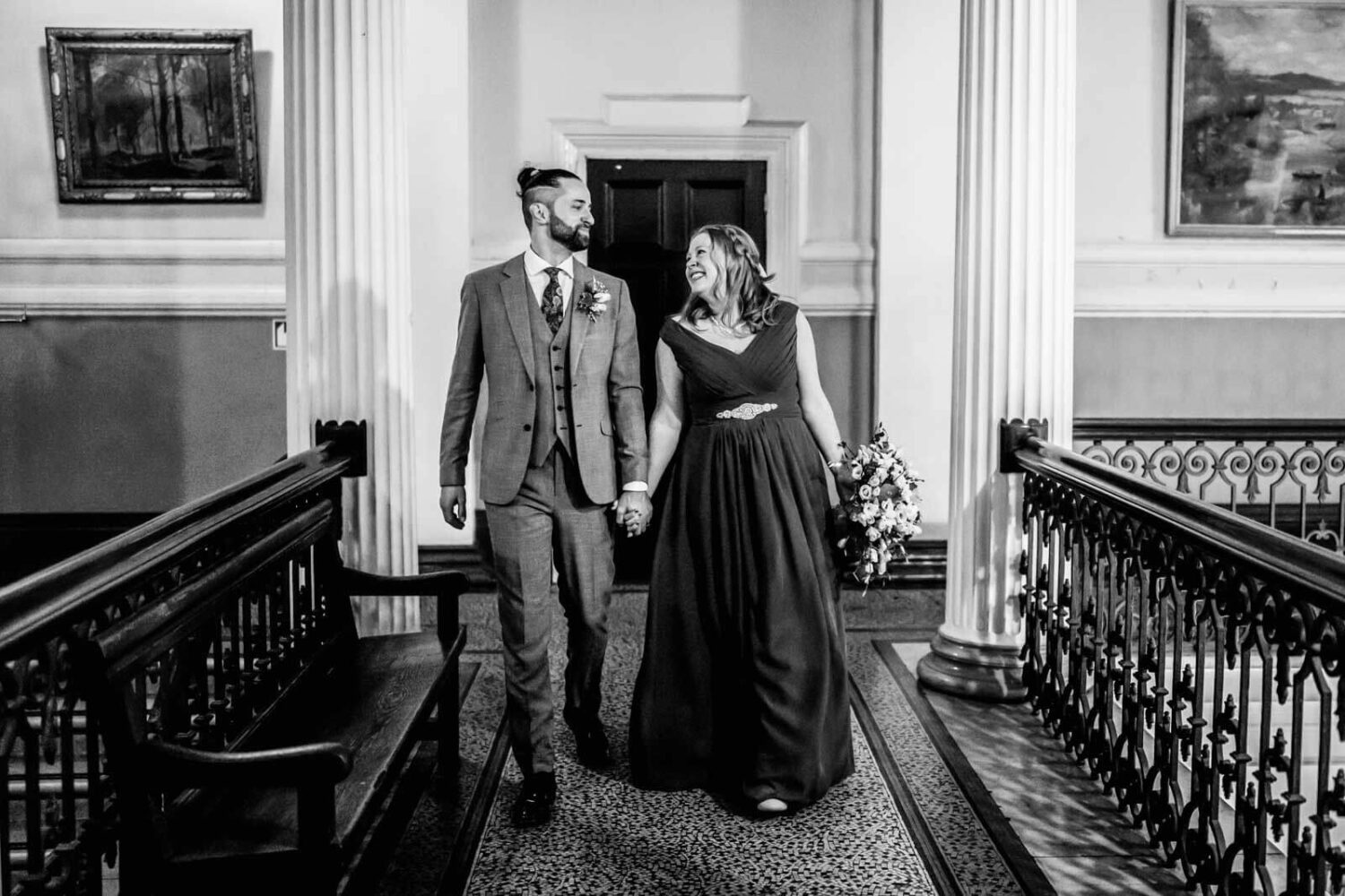 inside brighton town hall bride and groom walking down stairs