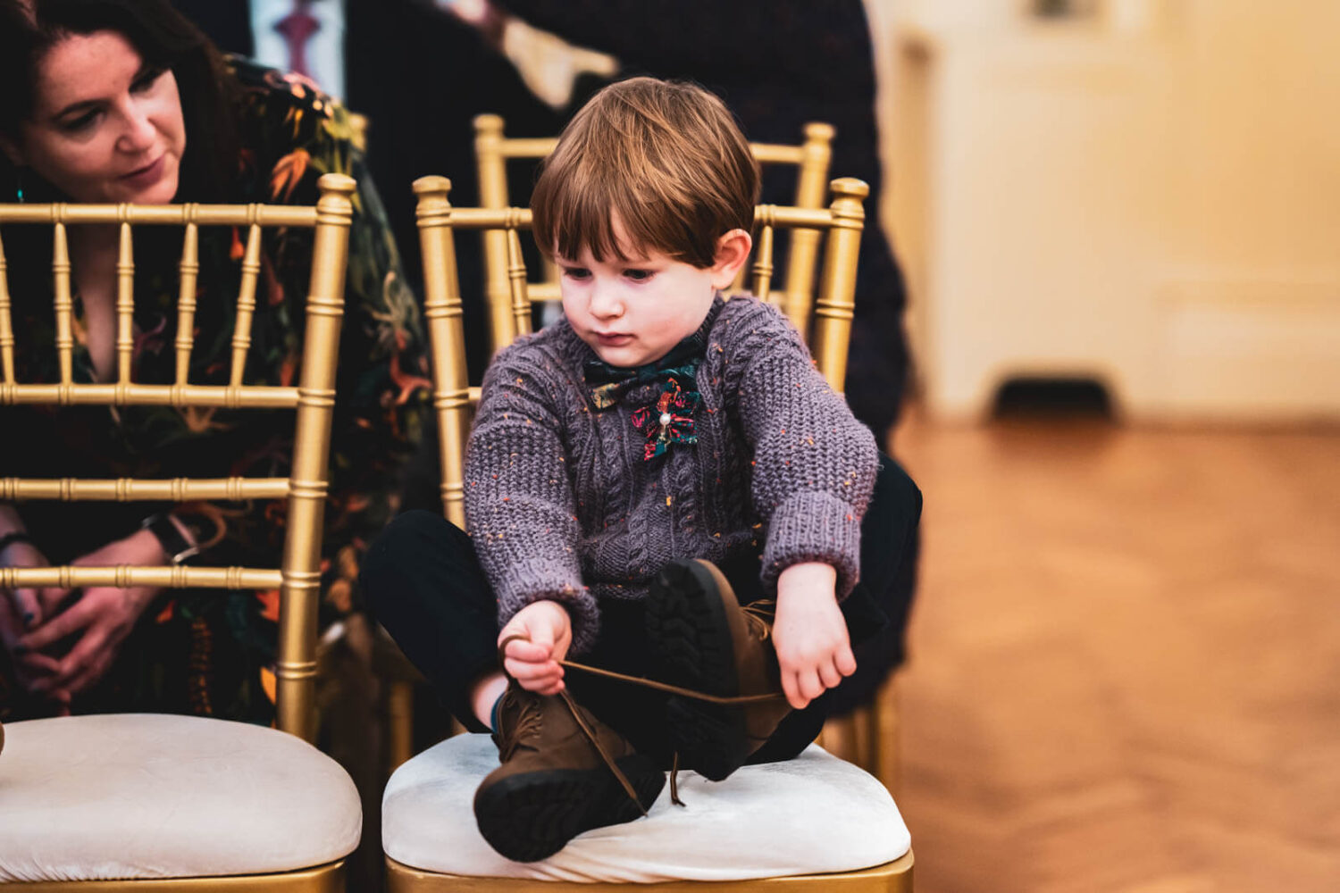 boy on chair waiting for wedding to start
