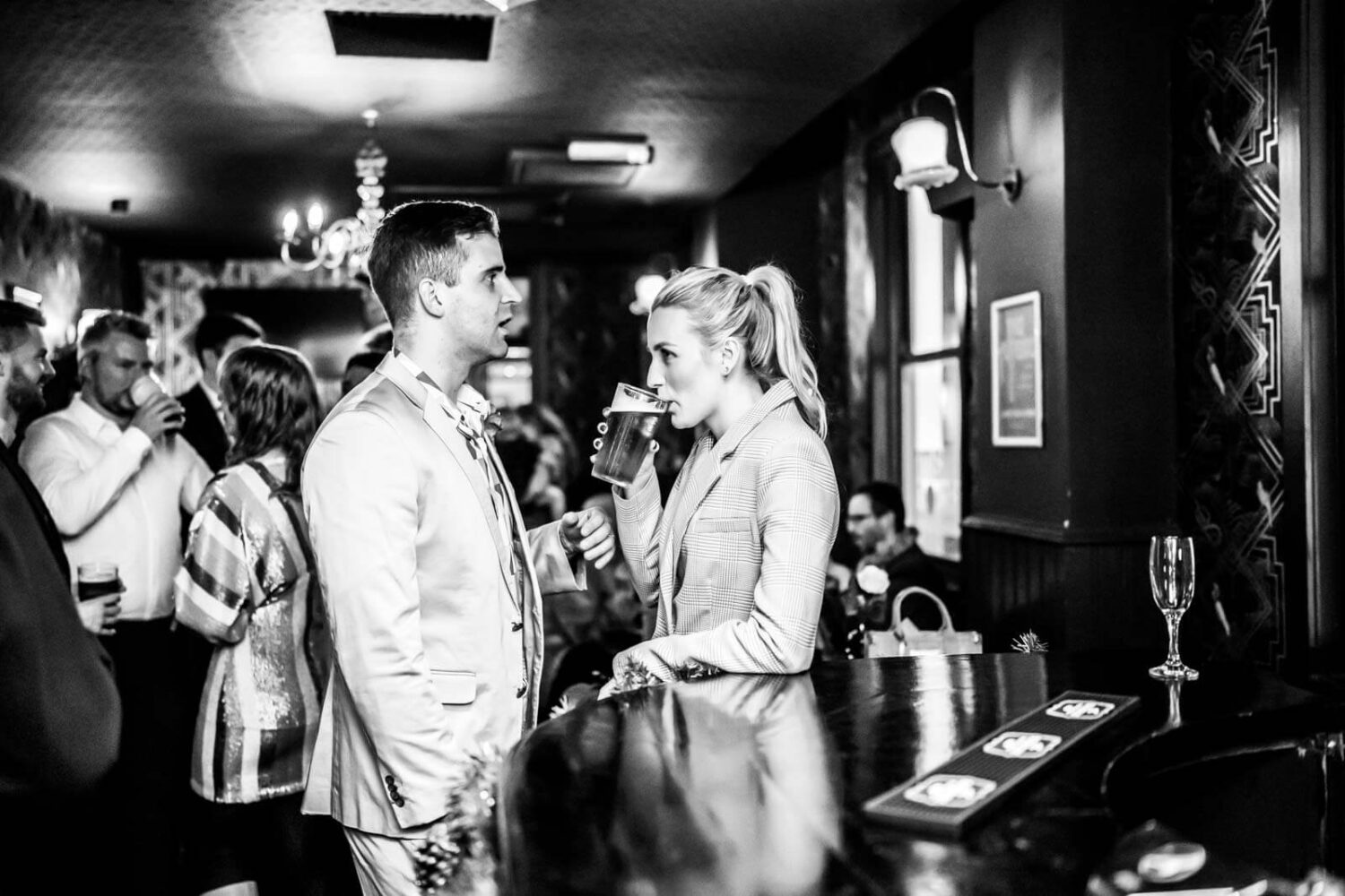 couple drinking pints in bar