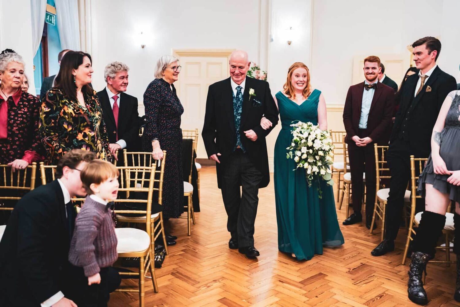 bride walking down aisle with father in brighton town hall