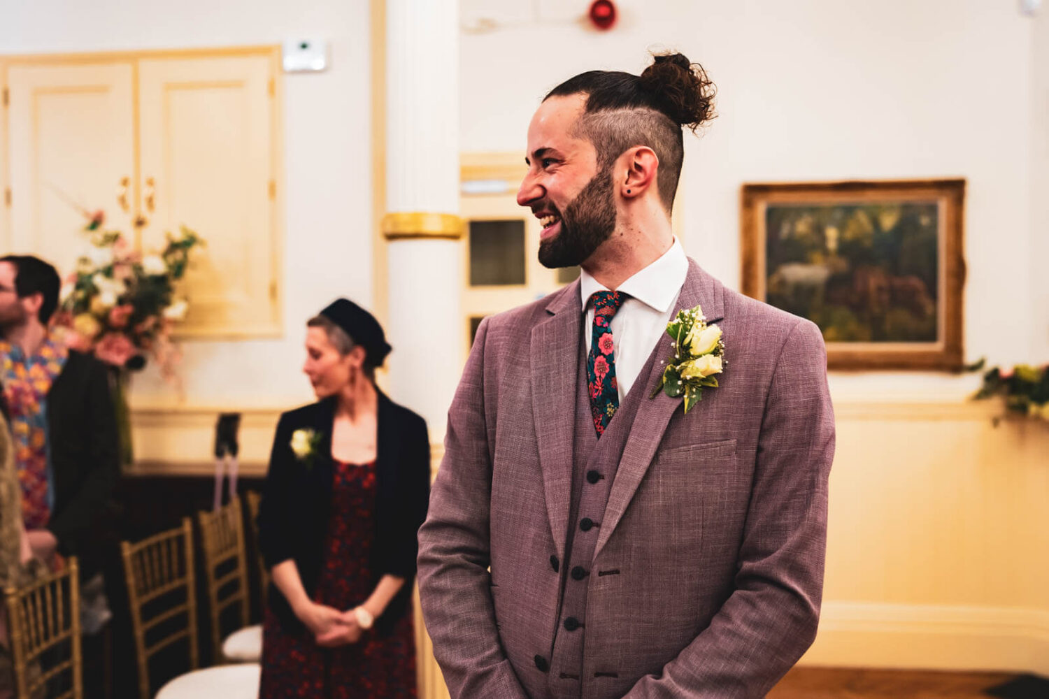 groom looking happy as bride walks in