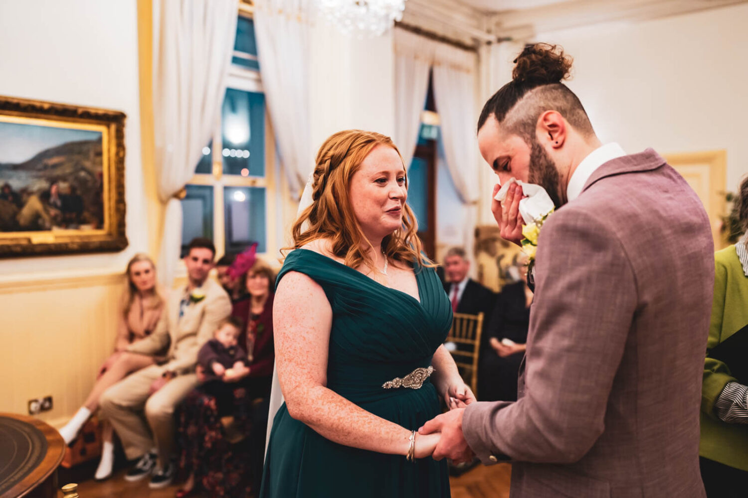 groom wipes away tears