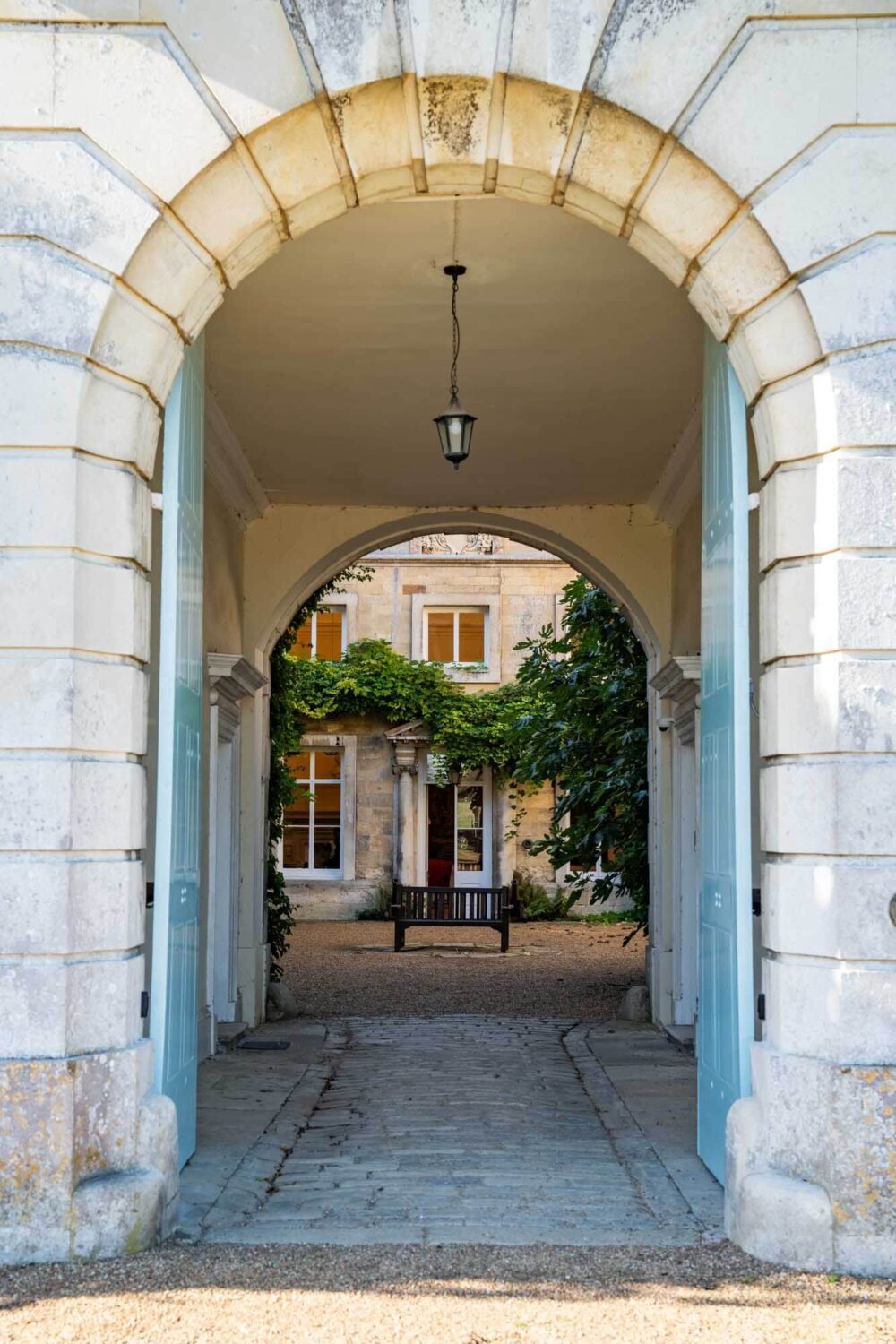 blue doors at firle place leading to courtyard