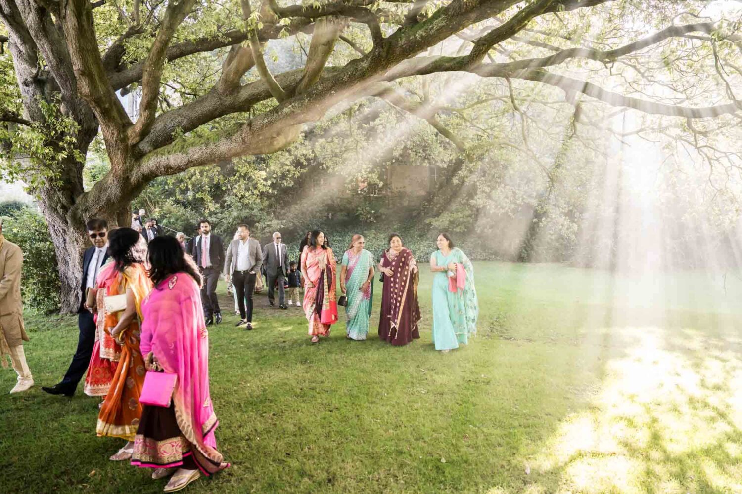 smokey shadows with guests walking through gardens at firle place